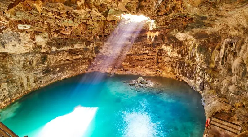 A limestone cenote near Tulum with clear turquoise water